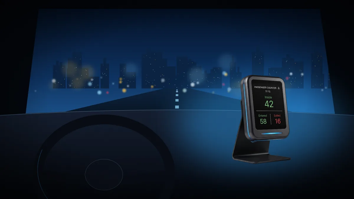 The driver display glowing blue on the dashboard with the live passenger count